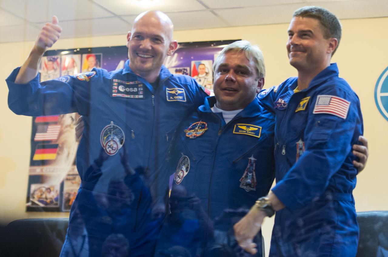 Expedition 40 Flight Engineer Alexander Gerst of the European Space Agency, ESA, left, Soyuz Commander Maxim Suraev of the Russian Federal Space Agency, Roscosmos, center, and Flight Engineer Reid Wiseman of NASA, left, are seen together during a press conference, Tuesday, May 27, 2014, at the Cosmonaut Hotel in Baikonur, Kazakhstan. Their mission to the International Space Station is set to launch May 29 from the Baikonur Cosmodrome. Photo Credit: (NASA/Joel Kowsky)