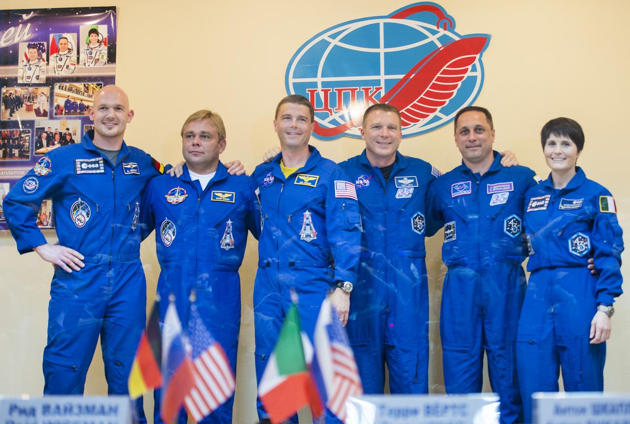 Expedition 40 prime crew members Flight Engineer Alexander Gerst of the European Space Agency, ESA, far left, Soyuz Commander Maxim Suraev of the Russian Federal Space Agency, Roscosmos, second left, and Flight Engineer Reid Wiseman of NASA, center, pose for a picture with Expedition 40 backup crew members Flight Engineer Terry Virts of NASA, third right, Soyuz Commander Anton Shkaplerov of Roscosmos, and Flight Engineer Samantha Cristoforetti of ESA at the conclusion a press conference, Tuesday, May 27, 2014, at the Cosmonaut Hotel in Baikonur, Kazakhstan. The mission to the International Space Station is set to launch May 29 from the Baikonur Cosmodrome. Photo Credit: (NASA/Joel Kowsky)