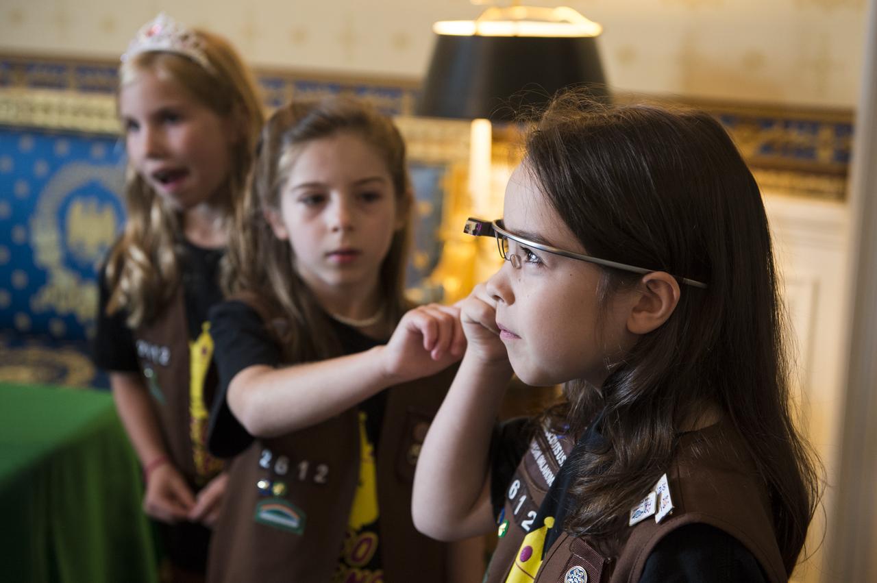 Girl Scout troop 2612 members from Tulsa, OK take photos of one another with Google Glass at the White House Science Fair Tuesday, May 27, 2014. Avery Dodson, 6; Natalie Hurley, 8; Miriam Schaffer, 8; Claire Winton, 8; and Lucy Claire Sharp, 8 participated in the Junior FIRST Lego League's Disaster Blaster Challenge, which invites elementary-school-aged students from across the country to explore how simple machines, engineering, and math can help solve problems posed by natural disasters. The girls invented the "Flood Proof Bridge" and built a model mechanizing the bridge using motors and developing a computer program to automatically retract the bridge when flood conditions are detected. The fourth White House Science Fair was held at the White House and included 100 students from more than 30 different states who competed in science, technology, engineering, and math (STEM) competitions. (Photo Credit: NASA/Aubrey Gemignani)
