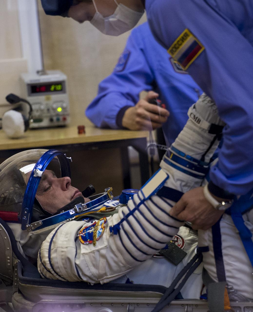 Expedition 40 Soyuz Commander Maxim Suraev of the Russian Federal Space Agency, Roscosmos, has his Russian Sokol suit pressure checked in preparation for his launch onboard the Soyuz TMA-13M spacecraft on Wednesday, May 28, 2014 at the Baikonur Cosmodrome in Kazakhstan. The Soyuz spacecraft with Suraev, Expedition 40 Flight Engineer Alexander Gerst of the European Space Agency, ESA, and Flight Engineer Reid Wiseman of NASA is scheduled to launch at 1:57 a.m. Kazakhstan Time on Thursday, May 29. Photo Credit: (NASA/Joel Kowsky)