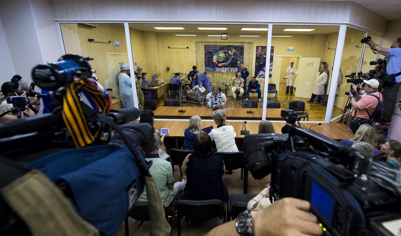 Expedition 40 Soyuz Commander Maxim Suraev of the Russian Federal Space Agency, Roscosmos, speaks with his family after having his Russian Sokol suit pressure checked in preparation for his launch onboard the Soyuz TMA-13M spacecraft on Wednesday, May 28, 2014 at the Baikonur Cosmodrome in Kazakhstan. The Soyuz spacecraft with Suraev, Expedition 40 Flight Engineer Alexander Gerst of the European Space Agency, ESA, and Flight Engineer Reid Wiseman of NASA is scheduled to launch at 1:57 a.m. Kazakhstan Time on Thursday, May 29. Photo Credit: (NASA/Joel Kowsky)