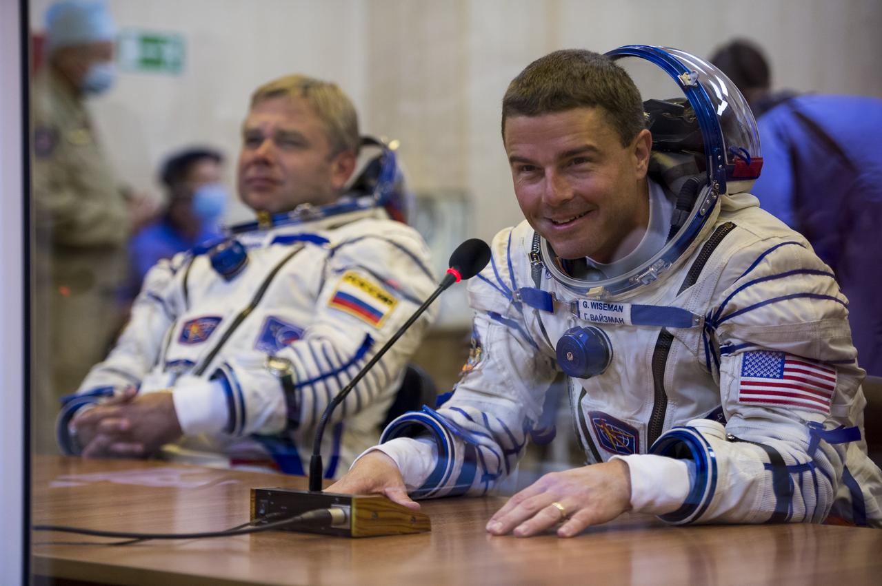 Expedition 40 Flight Engineer Reid Wiseman of NASA speaks with his family after having his Russian Sokol suit pressure checked in preparation for his launch onboard the Soyuz TMA-13M spacecraft on Wednesday, May 28, 2014 at the Baikonur Cosmodrome in Kazakhstan. The Soyuz spacecraft with Wiseman, Expedition 40 Soyuz Commander Maxim Suraev of the Russian Federal Space Agency, Roscosmos, and Flight Engineer Alexander Gerst of the European Space Agency, ESA, is scheduled to launch at 1:57 a.m. Kazakhstan time on Thursday, May 29. Photo Credit: (NASA/Joel Kowsky)