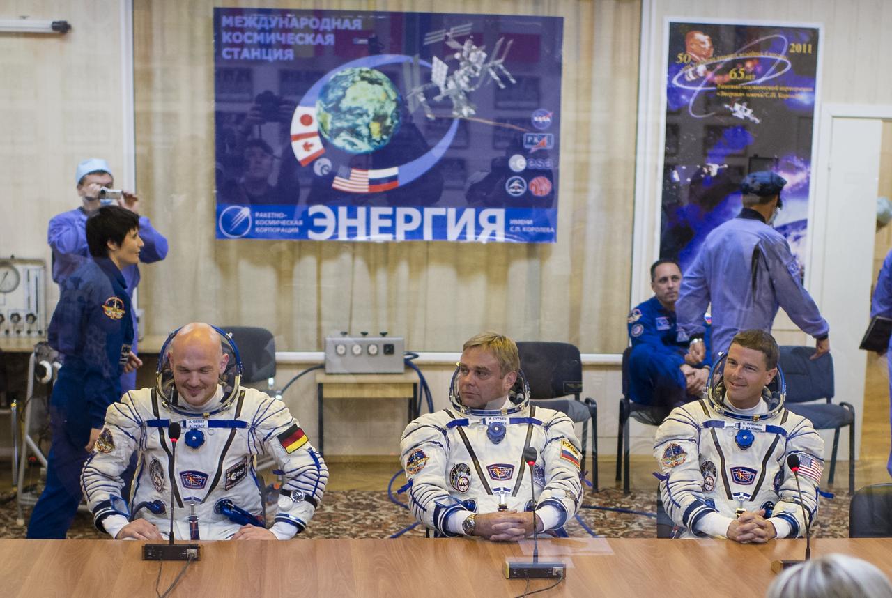 Expedition 40 Flight Engineer Alexander Gerst of the European Space Agency, ESA, left, Soyuz Commander Maxim Suraev of the Russian Federal Space Agency, Roscosmos, center, and Flight Engineer Reid Wiseman of NASA, left, are seen after having their Russian Sokol suits pressure checked in preparation for their launch onboard the Soyuz TMA-13M spacecraft on Wednesday, May 28, 2014 at the Baikonur Cosmodrome in Kazakhstan. The trio is set to launch on a six month mission to the International Space Station onboard the Soyuz TMA-13M spacecraft at 1:57 a.m. Kazakhstan time on Thursday, May 29. Photo Credit: (NASA/Joel Kowsky)