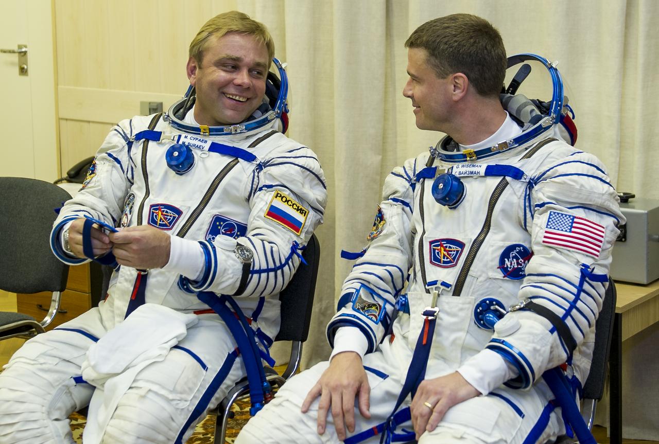 Expedition 40 Soyuz Commander Maxim Suraev of the Russian Federal Space Agency, Roscosmos, left and Flight Engineer Reid Wiseman of NASA are seen after being helped into their Russian Sokol suit as the pair and fellow cremate, Flight Engineer Alexander Gerst of the European Space Agency, ESA, prepare for their Soyuz launch to the International Space Station, on Wednesday, May 28, 2014, in Baikonur, Kazakhstan. Launch of the Soyuz rocket will send Suraev, Gerst, and Wiseman on a five and a half month mission aboard the International Space Station. Photo Credit: (NASA/GCTC/Irina Peshkova)