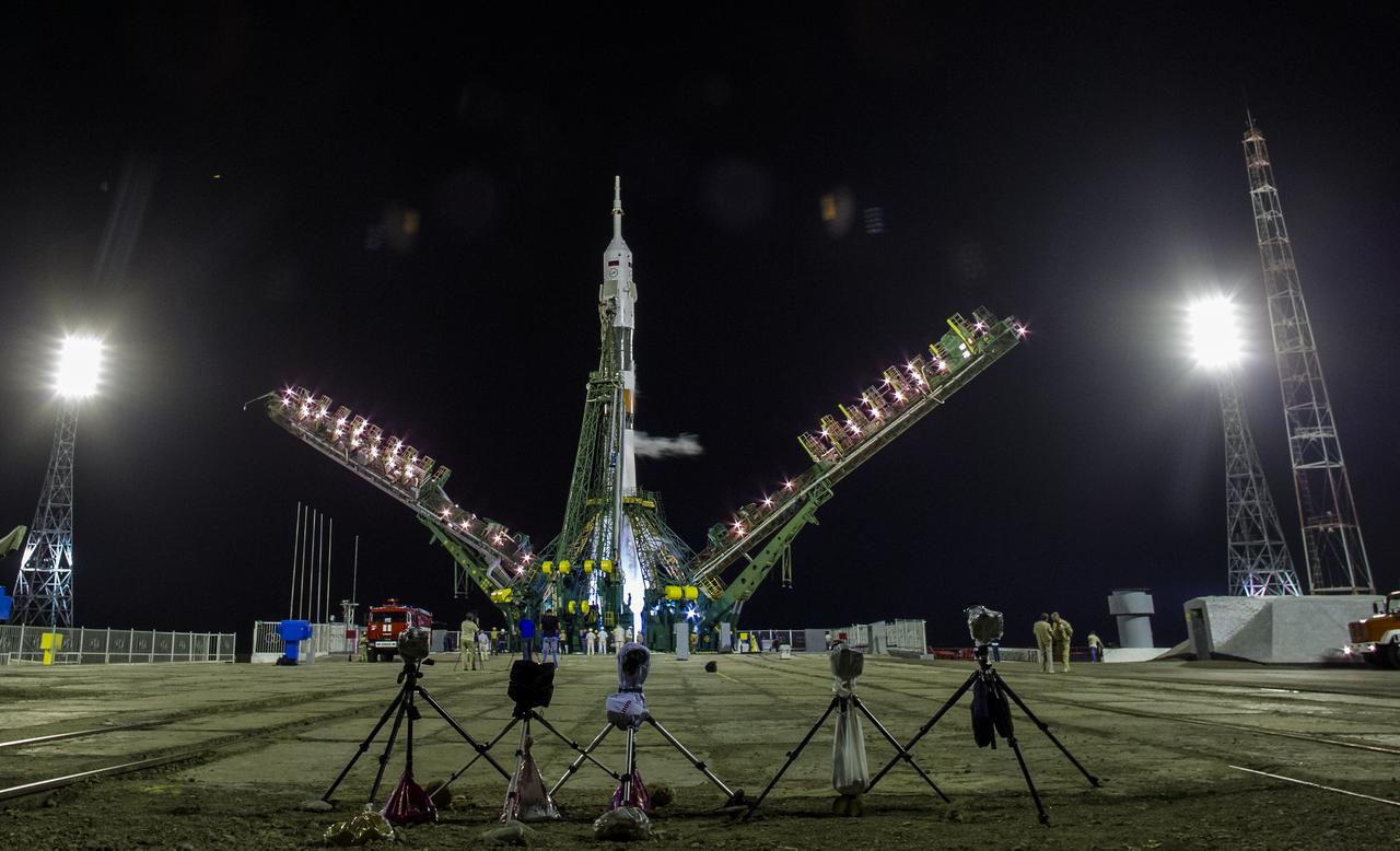 The Soyuz TMA-13M rocket is seen as the service structure lowered in preperation for launch in the early morning hours of Thursday, May 29, 2014 at the Baikonur Cosmodrome in Kazakhstan. Launch of the Soyuz rocket will send Expedition 40 Soyuz Commander Maxim Suraev, of the Russian Federal Space Agency, Roscosmos, Flight Engineer Alexander Gerst, of the European Space Agency, ESA, and Flight Engineer Reid Wiseman of NASA on a five and a half month mission aboard the International Space Station. Photo Credit: (NASA/Joel Kowsky)