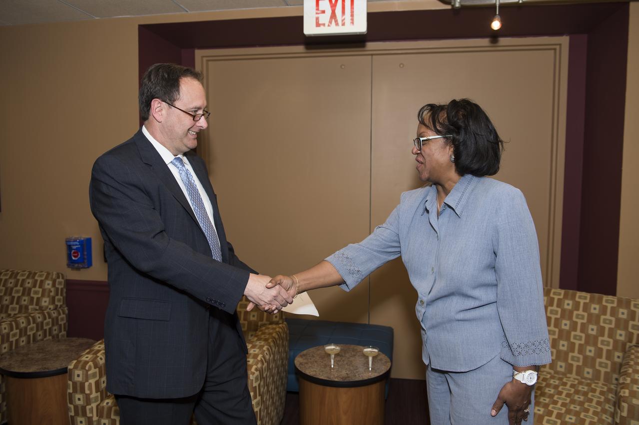 Sumara Thompson-King is seen here after being sworn in by Robert Lightfoot, Associate Administrator (left) at NASA Headquarters in Washington, DC on June 2, 2014. Thompson-King assumed the role of General Counsel on Sunday, June 1, 2014 after Michael Wholley, former General Counsel, retired. She started her career at NASA in the Office of Chief Counsel at Goddard Space Flight Center in Greenbelt, MD in 1986. In 1991, she became a senior attorney at NASA Headquarters and in 1995 was promoted to the Deputy Associate General Counsel (Contracts) position. She is the first woman and first African American to serve as General Counsel at NASA Headquarters. (Photo Credit: NASA/Aubrey Gemignani)