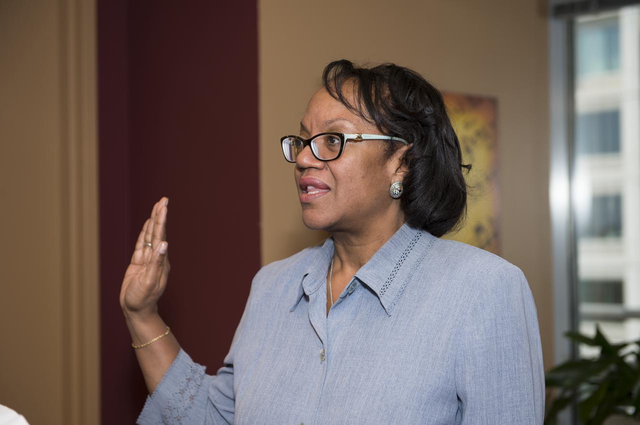 Sumara Thompson-King is seen here being sworn in by Robert Lightfoot, Associate Administrator (not pictured) at NASA Headquarters in Washington, DC on June 2, 2014. Thompson-King assumed the role of General Counsel on Sunday, June 1, 2014 after Michael Wholley, former General Counsel, retired. She started her career at NASA in the Office of Chief Counsel at Goddard Space Flight Center in Greenbelt, MD in 1986. In 1991, she became a senior attorney at NASA Headquarters and in 1995 was promoted to the Deputy Associate General Counsel (Contracts) position. She is the first woman and first African American to serve as General Counsel at NASA Headquarters. (Photo Credit: NASA/Aubrey Gemignani)