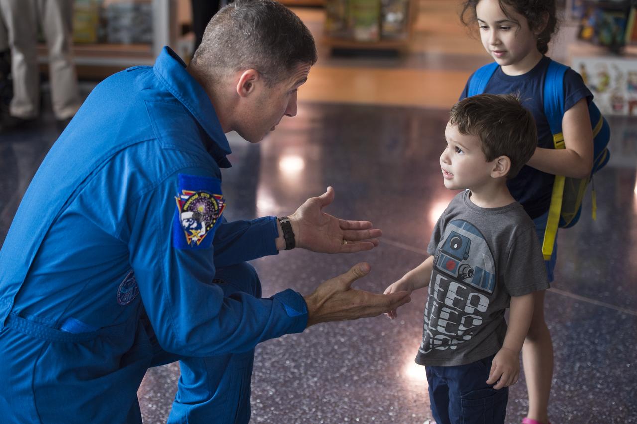NASA Astronaut Mike Hopkins explains what it was like to live on the International Space Station for 6 months to visitors at the Maryland Science Center in Baltimore, MD on Monday, June 9, 2014. Hopkins served on Expeditions 37 and 38 with Russian cosmonauts Oleg Kotov and Sergey Ryazanskiy and returned home in March, 2014.  (Photo Credit: NASA/Aubrey Gemignani)