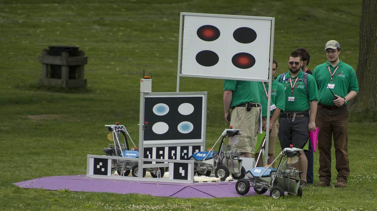 A team KuuKulgur robot is seen as it begins the level one challenge during the 2014 NASA Centennial Challenges Sample Return Robot Challenge, Wednesday, June 11, 2014, at the Worcester Polytechnic Institute (WPI) in Worcester, Mass.   Eighteen teams are competing for a $1.5 million NASA prize purse. Teams will be required to demonstrate autonomous robots that can locate and collect samples from a wide and varied terrain, operating without human control. The objective of this NASA-WPI Centennial Challenge is to encourage innovations in autonomous navigation and robotics technologies. Innovations stemming from the challenge may improve NASA's capability to explore a variety of destinations in space, as well as enhance the nation's robotic technology for use in industries and applications on Earth. Photo Credit: (NASA/Joel Kowsky)