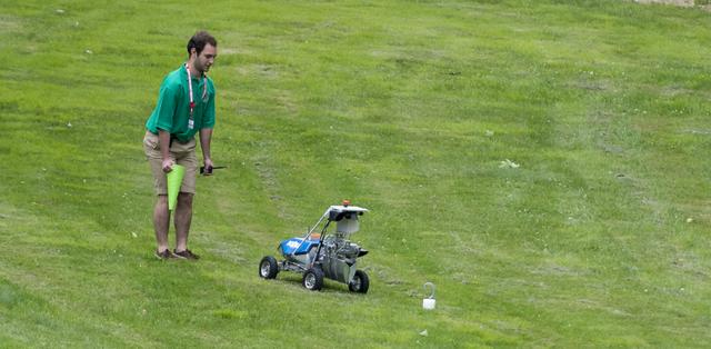 A team KuuKulgur robot approaches the sample as it attempts the level one challenge during the 2014 NASA Centennial Challenges Sample Return Robot Challenge, Wednesday, June 11, 2014, at the Worcester Polytechnic Institute (WPI) in Worcester, Mass.   Eighteen teams are competing for a $1.5 million NASA prize purse. Teams will be required to demonstrate autonomous robots that can locate and collect samples from a wide and varied terrain, operating without human control. The objective of this NASA-WPI Centennial Challenge is to encourage innovations in autonomous navigation and robotics technologies. Innovations stemming from the challenge may improve NASA's capability to explore a variety of destinations in space, as well as enhance the nation's robotic technology for use in industries and applications on Earth. Photo Credit: (NASA/Joel Kowsky)