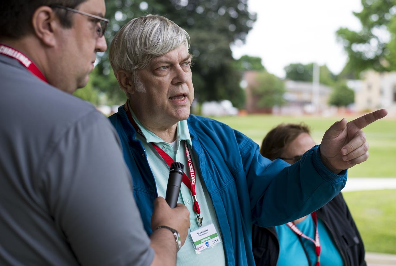 Jerry Waechter of team Middleman from Dunedin, Florida, speaks about his team's robot, Ro-Bear, as it makes it attempt at the level one challenge during the 2014 NASA Centennial Challenges Sample Return Robot Challenge, Wednesday, June 11, 2014, at the Worcester Polytechnic Institute (WPI) in Worcester, Mass.   Eighteen teams are competing for a $1.5 million NASA prize purse. Teams will be required to demonstrate autonomous robots that can locate and collect samples from a wide and varied terrain, operating without human control. The objective of this NASA-WPI Centennial Challenge is to encourage innovations in autonomous navigation and robotics technologies. Innovations stemming from the challenge may improve NASA's capability to explore a variety of destinations in space, as well as enhance the nation's robotic technology for use in industries and applications on Earth. Photo Credit: (NASA/Joel Kowsky)