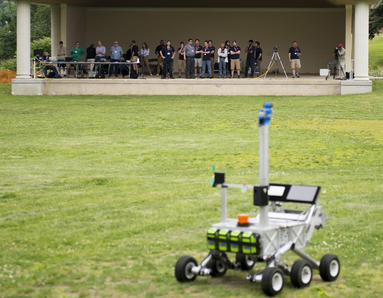 The Mountaineers team from West Virginia University, watches as their robot attempts the level one challenge during the 2014 NASA Centennial Challenges Sample Return Robot Challenge, Wednesday, June 11, 2014, at the Worcester Polytechnic Institute (WPI) in Worcester, Mass.   Eighteen teams are competing for a $1.5 million NASA prize purse. Teams will be required to demonstrate autonomous robots that can locate and collect samples from a wide and varied terrain, operating without human control. The objective of this NASA-WPI Centennial Challenge is to encourage innovations in autonomous navigation and robotics technologies. Innovations stemming from the challenge may improve NASA's capability to explore a variety of destinations in space, as well as enhance the nation's robotic technology for use in industries and applications on Earth. Photo Credit: (NASA/Joel Kowsky)