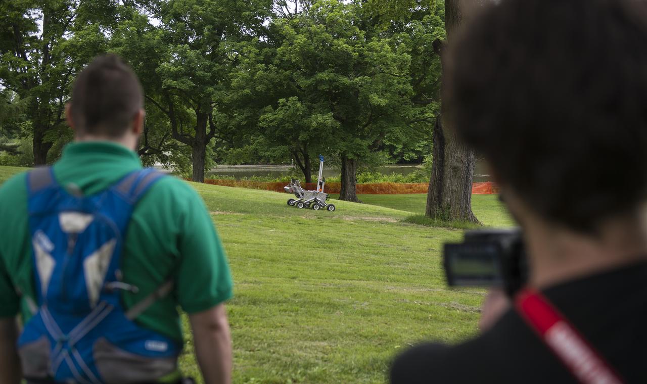 The team Mountaineers robot is seen as it attempts the level one challenge during the 2014 NASA Centennial Challenges Sample Return Robot Challenge, Wednesday, June 11, 2014, at the Worcester Polytechnic Institute (WPI) in Worcester, Mass.   Eighteen teams are competing for a $1.5 million NASA prize purse. Teams will be required to demonstrate autonomous robots that can locate and collect samples from a wide and varied terrain, operating without human control. The objective of this NASA-WPI Centennial Challenge is to encourage innovations in autonomous navigation and robotics technologies. Innovations stemming from the challenge may improve NASA's capability to explore a variety of destinations in space, as well as enhance the nation's robotic technology for use in industries and applications on Earth. Photo Credit: (NASA/Joel Kowsky)