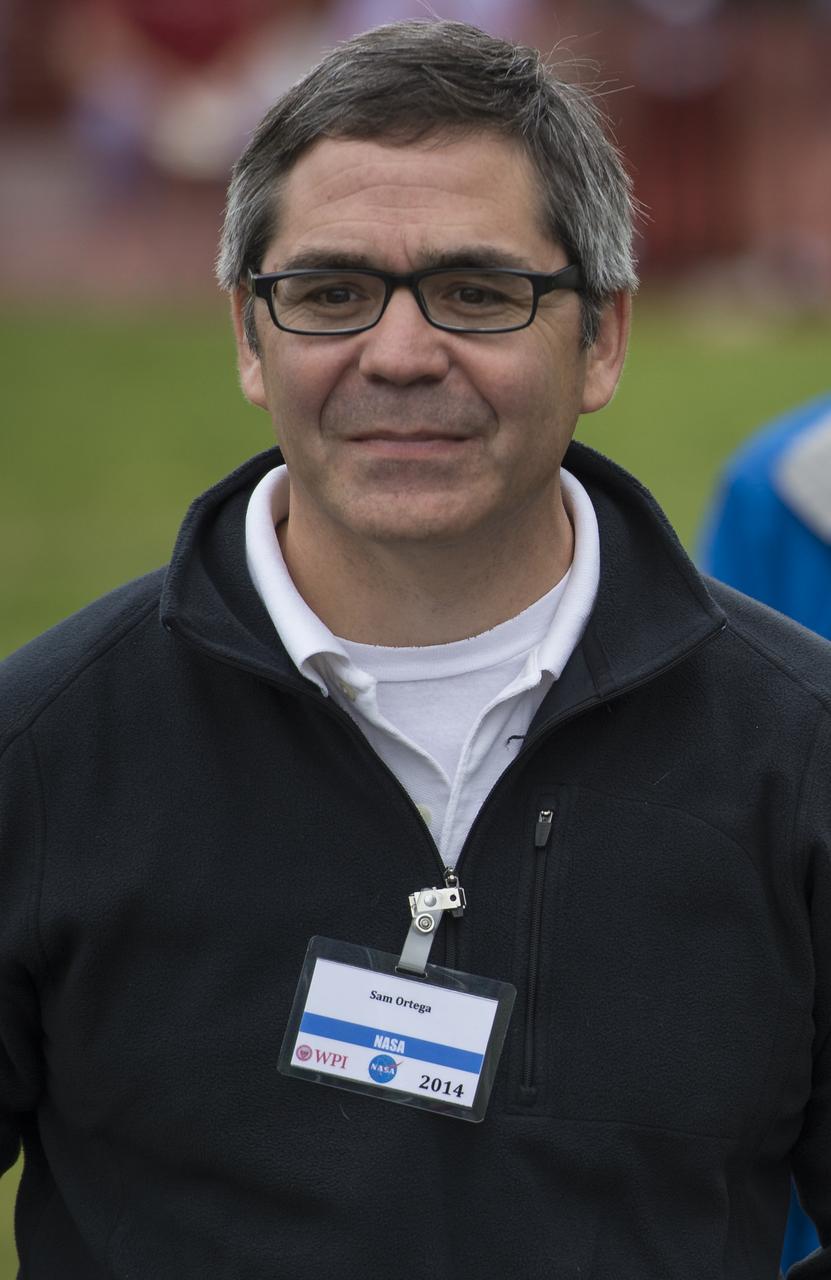 Sam Ortega, NASA program manager for Centennial Challenges, is seen during the 2014 NASA Centennial Challenges Sample Return Robot Challenge, Thursday, June 12, 2014, at the Worcester Polytechnic Institute (WPI) in Worcester, Mass.   Eighteen teams are competing for a $1.5 million NASA prize purse. Teams will be required to demonstrate autonomous robots that can locate and collect samples from a wide and varied terrain, operating without human control. The objective of this NASA-WPI Centennial Challenge is to encourage innovations in autonomous navigation and robotics technologies. Innovations stemming from the challenge may improve NASA's capability to explore a variety of destinations in space, as well as enhance the nation's robotic technology for use in industries and applications on Earth. Photo Credit: (NASA/Joel Kowsky)