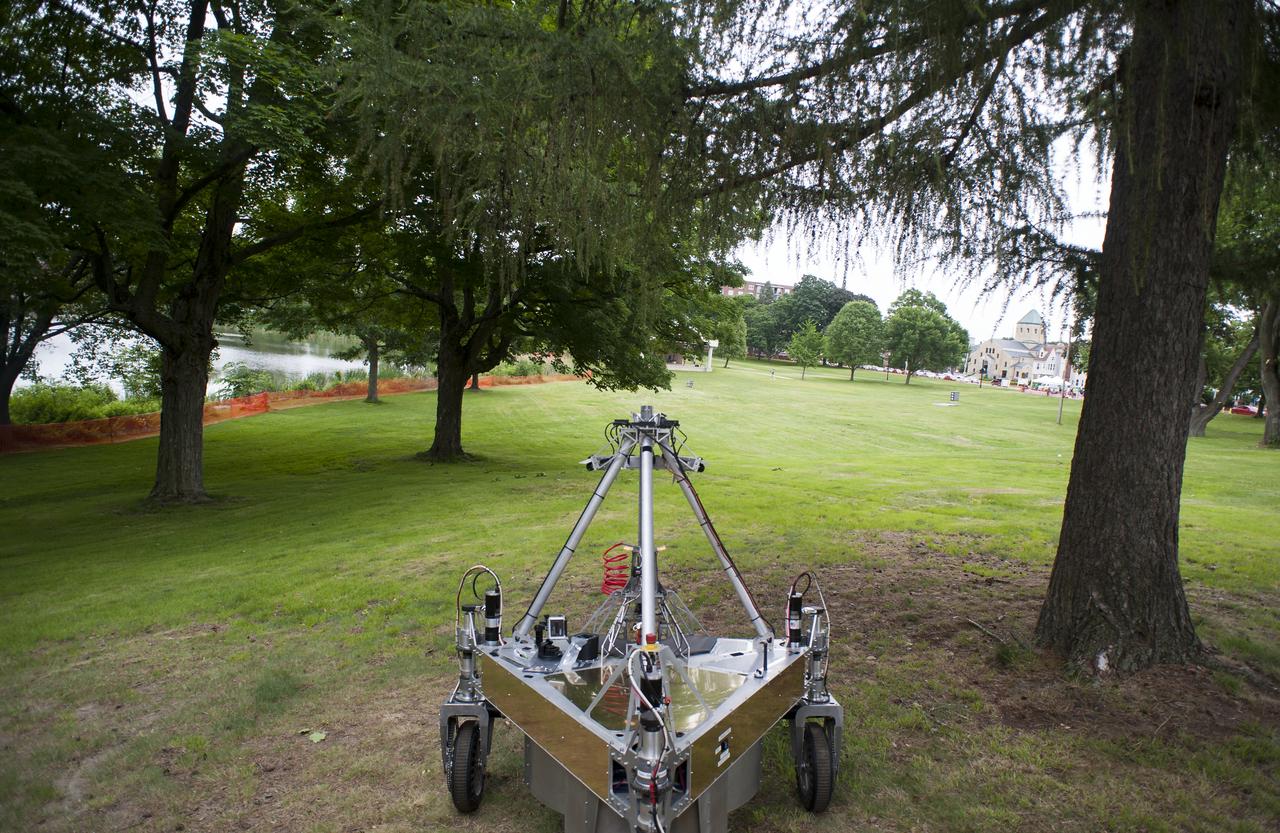 Team Survey's robot is seen as it conducts a demonstration of the level two challenge during the 2014 NASA Centennial Challenges Sample Return Robot Challenge, Thursday, June 12, 2014, at the Worcester Polytechnic Institute (WPI) in Worcester, Mass.   Eighteen teams are competing for a $1.5 million NASA prize purse. Teams will be required to demonstrate autonomous robots that can locate and collect samples from a wide and varied terrain, operating without human control. The objective of this NASA-WPI Centennial Challenge is to encourage innovations in autonomous navigation and robotics technologies. Innovations stemming from the challenge may improve NASA's capability to explore a variety of destinations in space, as well as enhance the nation's robotic technology for use in industries and applications on Earth. Photo Credit: (NASA/Joel Kowsky)