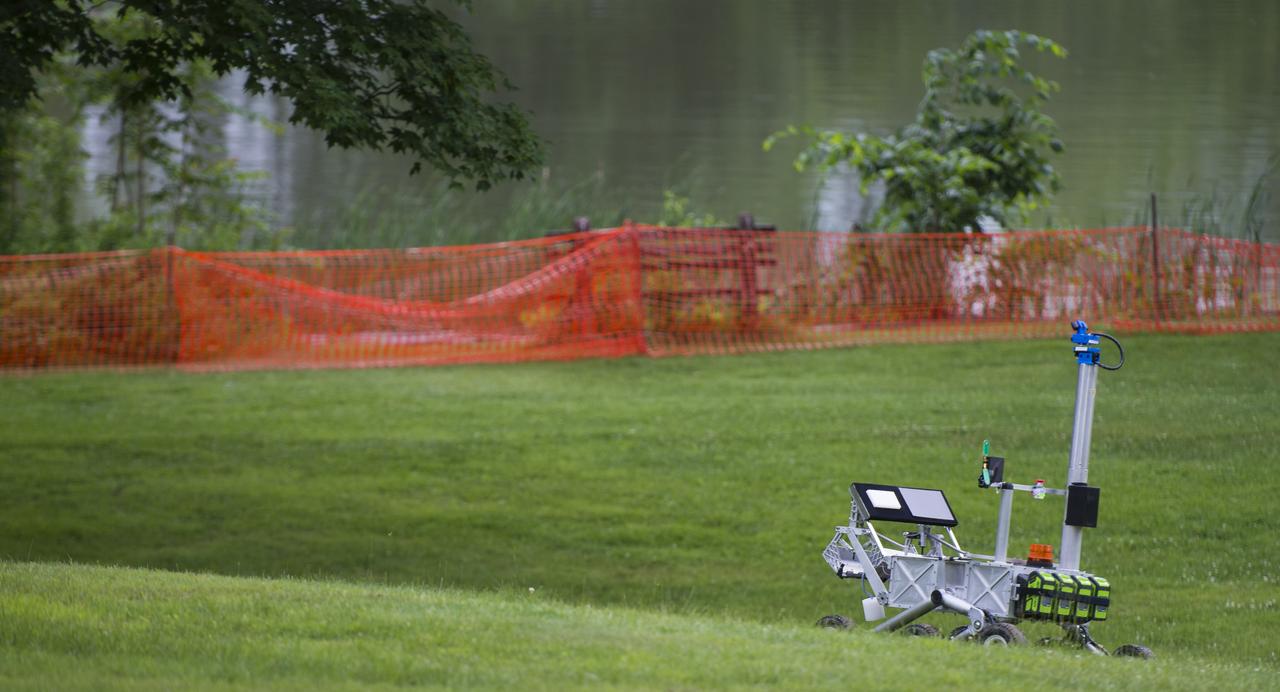 The team Mountaineers robot is seen after picking up the sample during a rerun of the level one challenge at the 2014 NASA Centennial Challenges Sample Return Robot Challenge, Saturday, June 14, 2014, at the Worcester Polytechnic Institute (WPI) in Worcester, Mass.   Eighteen teams are competing for a $1.5 million NASA prize purse. Teams will be required to demonstrate autonomous robots that can locate and collect samples from a wide and varied terrain, operating without human control. The objective of this NASA-WPI Centennial Challenge is to encourage innovations in autonomous navigation and robotics technologies. Innovations stemming from the challenge may improve NASA's capability to explore a variety of destinations in space, as well as enhance the nation's robotic technology for use in industries and applications on Earth. Photo Credit: (NASA/Joel Kowsky)