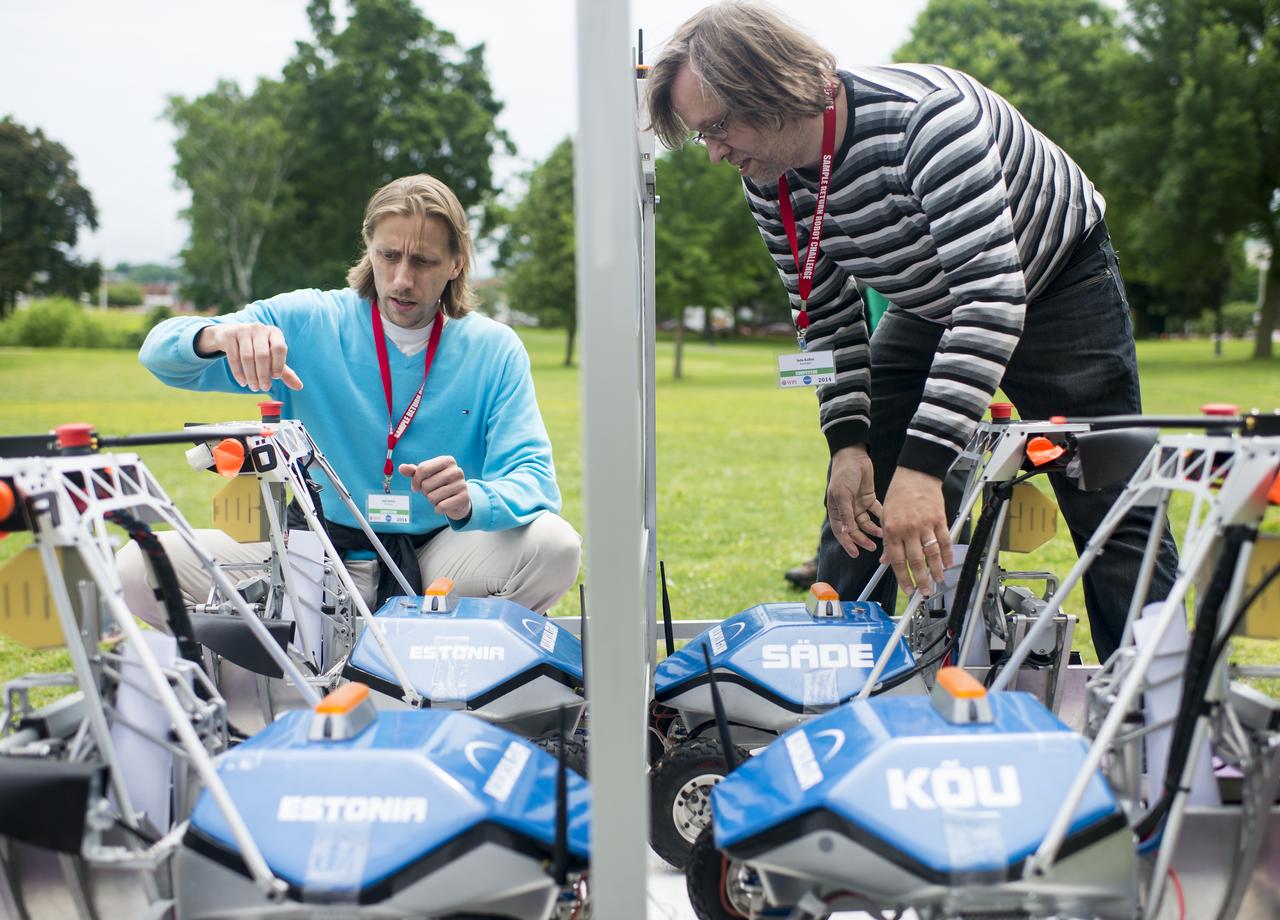 Ahti Heinla, left, and Sulo Kallas, right, from Estonia, prepare team KuuKulgur's robot for the rerun of the level one challenge during the 2014 NASA Centennial Challenges Sample Return Robot Challenge, Saturday, June 14, 2014, at the Worcester Polytechnic Institute (WPI) in Worcester, Mass.   Eighteen teams are competing for a $1.5 million NASA prize purse. Teams will be required to demonstrate autonomous robots that can locate and collect samples from a wide and varied terrain, operating without human control. The objective of this NASA-WPI Centennial Challenge is to encourage innovations in autonomous navigation and robotics technologies. Innovations stemming from the challenge may improve NASA's capability to explore a variety of destinations in space, as well as enhance the nation's robotic technology for use in industries and applications on Earth. Photo Credit: (NASA/Joel Kowsky)