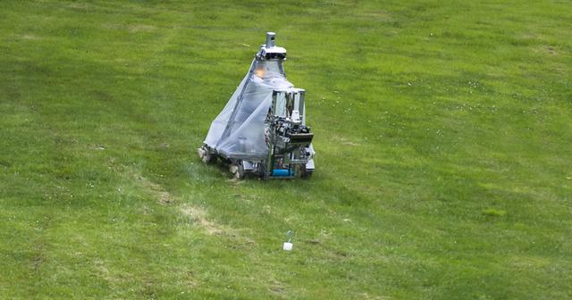 A robot from the University of Waterloo Robotics Team is seen during the rerun of the level one challenge during the 2014 NASA Centennial Challenges Sample Return Robot Challenge, Saturday, June 14, 2014, at the Worcester Polytechnic Institute (WPI) in Worcester, Mass.   Eighteen teams are competing for a $1.5 million NASA prize purse. Teams will be required to demonstrate autonomous robots that can locate and collect samples from a wide and varied terrain, operating without human control. The objective of this NASA-WPI Centennial Challenge is to encourage innovations in autonomous navigation and robotics technologies. Innovations stemming from the challenge may improve NASA's capability to explore a variety of destinations in space, as well as enhance the nation's robotic technology for use in industries and applications on Earth. Photo Credit: (NASA/Joel Kowsky)