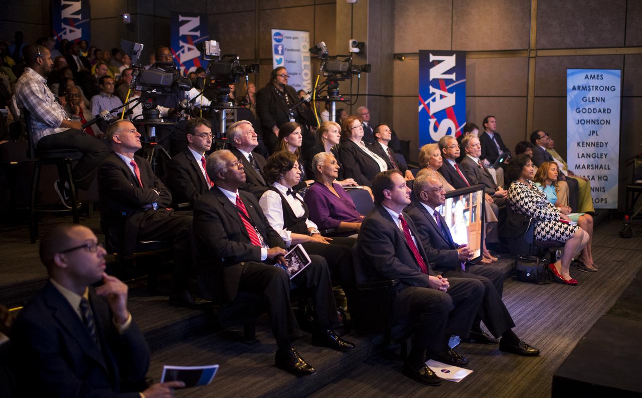 The audience watches as Nikki Giovanni, a poet and professor at Virginia Polytechnic and State University, reads her poem entitled "Quilting the Black-Eyed Pea (We’re Going to Mars)" via a pre-recorded video at at an event celebrating the 50th Anniversary of the Civil Rights Act of 1964 on Monday, June 23, 2014 in the James E. Webb Auditorium at NASA Headquarters in Washington, DC.  The event highlighted the influence of the Civil Rights Act on NASA.  Photo Credit: (NASA/Joel Kowsky)