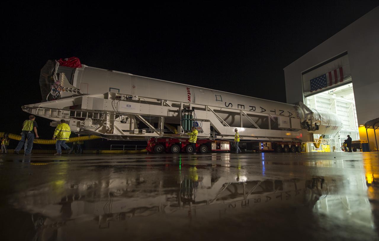 The Orbital Sciences Corporation Antares rocket, with the Cygnus spacecraft onboard, is rolled out of the Horizontal Integration Facility (HIF) to begin the approximately half-mile journey to launch Pad-0A, Thursday, July 10, 2014, at NASA's Wallops Flight Facility in Virginia. The Antares will launch with the Cygnus spacecraft filled with over 3,000 pounds of supplies for the International Space Station, including science experiments, experiment hardware, spare parts, and crew provisions. The Orbital-2 mission is Orbital Sciences' second contracted cargo delivery flight to the space station for NASA. Photo Credit: (NASA/Bill Ingalls)