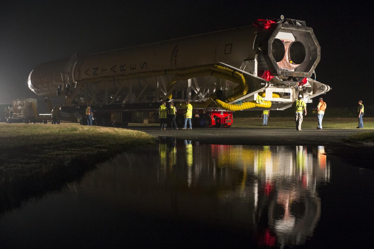 The Orbital Sciences Corporation Antares rocket, with the Cygnus spacecraft onboard, is rolled out of the Horizontal Integration Facility (HIF) to make the approximately half-mile journey to launch Pad-0A, Thursday, July 10, 2014, at NASA's Wallops Flight Facility in Virginia. The Antares will launch with the Cygnus spacecraft filled with over 3,000 pounds of supplies for the International Space Station, including science experiments, experiment hardware, spare parts, and crew provisions. The Orbital-2 mission is Orbital Sciences' second contracted cargo delivery flight to the space station for NASA. Photo Credit: (NASA/Aubrey Gemignani)