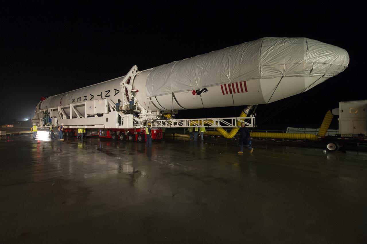 The Orbital Sciences Corporation Antares rocket, with the Cygnus spacecraft onboard, is rolled out of the Horizontal Integration Facility (HIF) to make the approximately half-mile journey to launch Pad-0A, Thursday, July 10, 2014, at NASA's Wallops Flight Facility in Virginia. The Antares will launch with the Cygnus spacecraft filled with over 3,000 pounds of supplies for the International Space Station, including science experiments, experiment hardware, spare parts, and crew provisions. The Orbital-2 mission is Orbital Sciences' second contracted cargo delivery flight to the space station for NASA. Photo Credit: (NASA/Aubrey Gemignani)