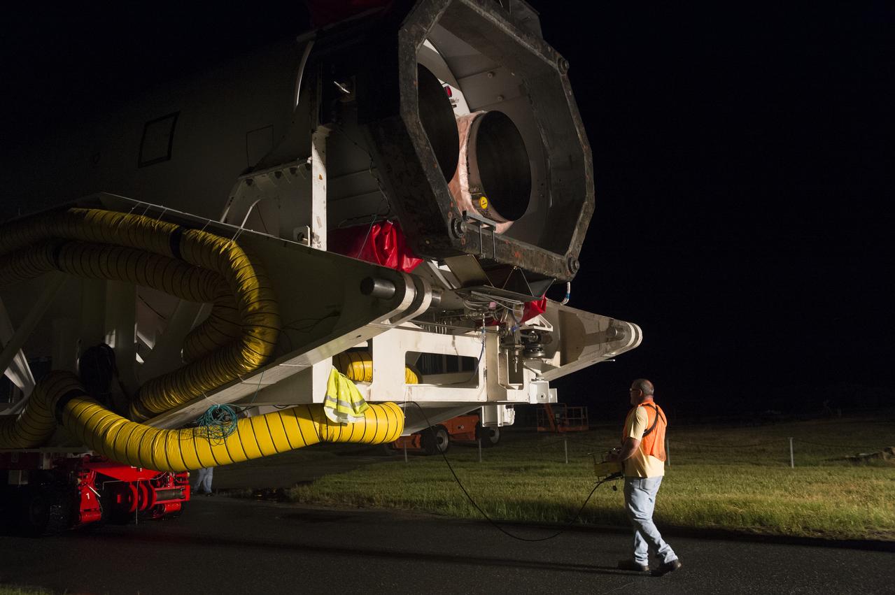 The Orbital Sciences Corporation Antares rocket, with the Cygnus spacecraft onboard, is rolled out of the Horizontal Integration Facility (HIF) to make the approximately half-mile journey to launch Pad-0A, Thursday, July 10, 2014, at NASA's Wallops Flight Facility in Virginia. The Antares will launch with the Cygnus spacecraft filled with over 3,000 pounds of supplies for the International Space Station, including science experiments, experiment hardware, spare parts, and crew provisions. The Orbital-2 mission is Orbital Sciences' second contracted cargo delivery flight to the space station for NASA. Photo Credit: (NASA/Aubrey Gemignani)