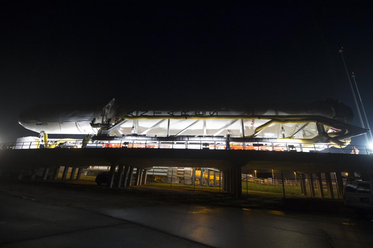The Orbital Sciences Corporation Antares rocket, with the Cygnus spacecraft onboard, arrives at launch Pad-0A, Thursday, July 10, 2014, at NASA's Wallops Flight Facility in Virginia. The Antares will launch with the Cygnus spacecraft filled with over 3,000 pounds of supplies for the International Space Station, including science experiments, experiment hardware, spare parts, and crew provisions. The Orbital-2 mission is Orbital Sciences' second contracted cargo delivery flight to the space station for NASA. Photo Credit: (NASA/Aubrey Gemignani)