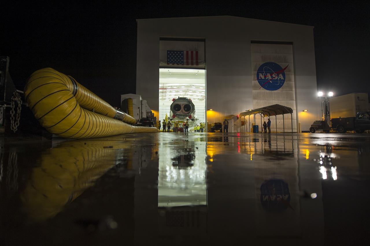 The Orbital Sciences Corporation Antares rocket, with the Cygnus spacecraft onboard, is rolled out of the Horizontal Integration Facility (HIF) to begin the approximately half-mile journey to launch Pad-0A, Thursday, July 10, 2014, at NASA's Wallops Flight Facility in Virginia. The Antares will launch with the Cygnus spacecraft filled with over 3,000 pounds of supplies for the International Space Station, including science experiments, experiment hardware, spare parts, and crew provisions. The Orbital-2 mission is Orbital Sciences' second contracted cargo delivery flight to the space station for NASA. Photo Credit: (NASA/Bill Ingalls)