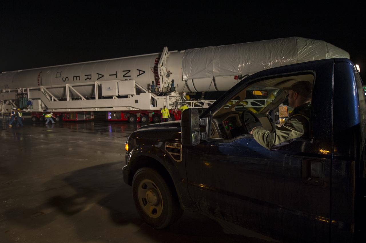 The Orbital Sciences Corporation Antares rocket, with the Cygnus spacecraft onboard, is rolled out of the Horizontal Integration Facility (HIF) to begin the approximately half-mile journey to launch Pad-0A, Thursday, July 10, 2014, at NASA's Wallops Flight Facility in Virginia. The Antares will launch with the Cygnus spacecraft filled with over 3,000 pounds of supplies for the International Space Station, including science experiments, experiment hardware, spare parts, and crew provisions. The Orbital-2 mission is Orbital Sciences' second contracted cargo delivery flight to the space station for NASA. Photo Credit: (NASA/Bill Ingalls)