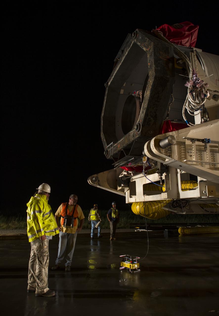 Workers prepare to drive the Orbital Sciences Corporation Antares rocket, with the Cygnus spacecraft onboard, from the Horizontal Integration Facility (HIF) to launch Pad-0A, Thursday, July 10, 2014, at NASA's Wallops Flight Facility in Virginia. The Antares will launch with the Cygnus spacecraft filled with over 3,000 pounds of supplies for the International Space Station, including science experiments, experiment hardware, spare parts, and crew provisions. The Orbital-2 mission is Orbital Sciences' second contracted cargo delivery flight to the space station for NASA. Photo Credit: (NASA/Bill Ingalls)