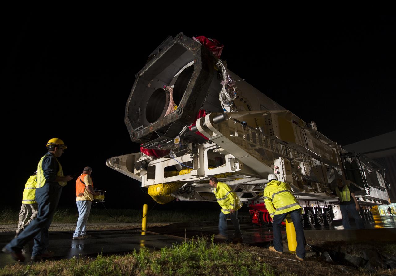 The Orbital Sciences Corporation Antares rocket, with the Cygnus spacecraft onboard, is rolled out of the Horizontal Integration Facility (HIF) to begin the approximately half-mile journey to launch Pad-0A, Thursday, July 10, 2014, at NASA's Wallops Flight Facility in Virginia. The Antares will launch with the Cygnus spacecraft filled with over 3,000 pounds of supplies for the International Space Station, including science experiments, experiment hardware, spare parts, and crew provisions. The Orbital-2 mission is Orbital Sciences' second contracted cargo delivery flight to the space station for NASA. Photo Credit: (NASA/Bill Ingalls)