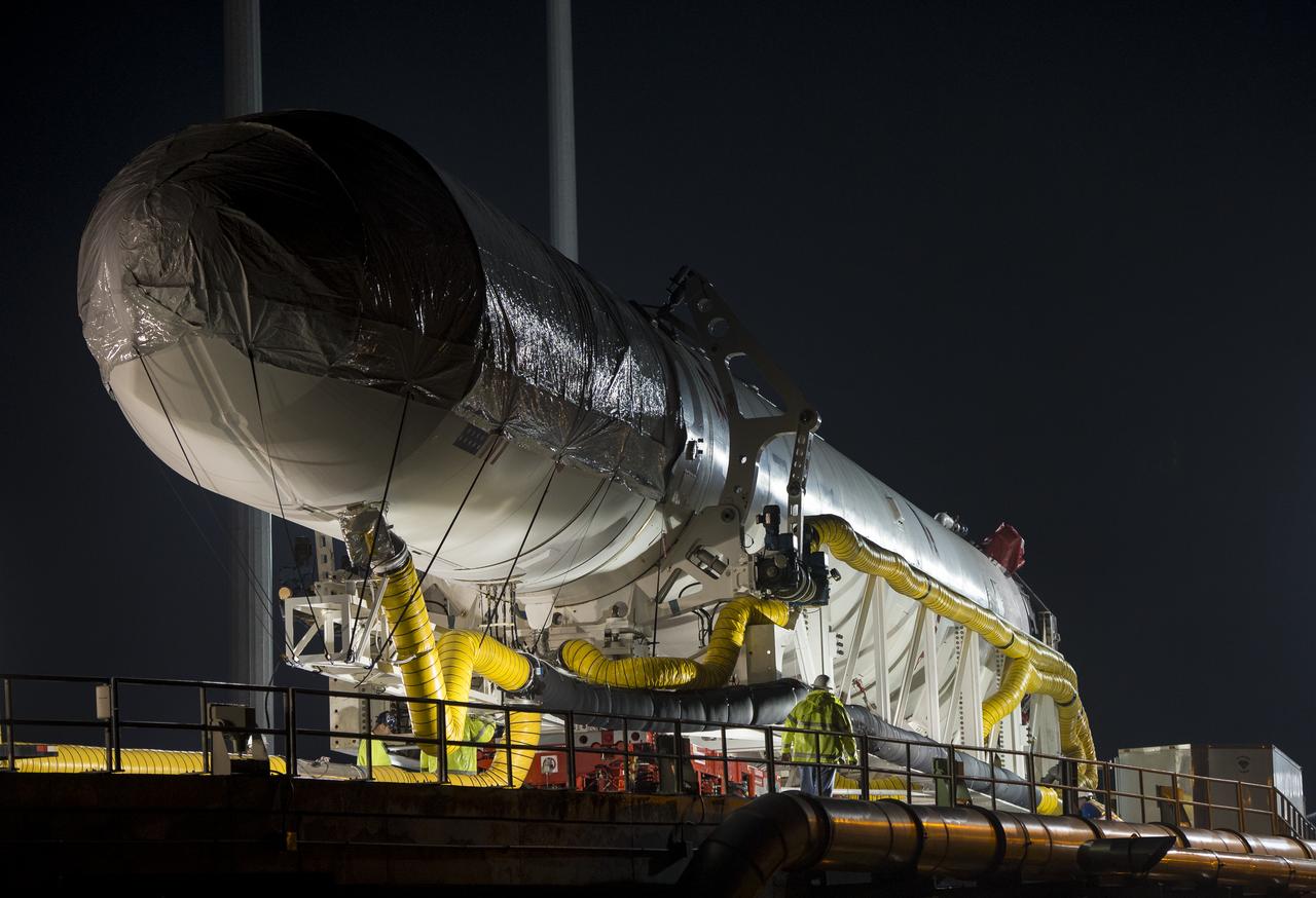The Orbital Sciences Corporation Antares rocket, with the Cygnus spacecraft onboard, arrives at launch Pad-0A, Thursday, July 10, 2014, at NASA's Wallops Flight Facility in Virginia. The Antares will launch with the Cygnus spacecraft filled with over 3,000 pounds of supplies for the International Space Station, including science experiments, experiment hardware, spare parts, and crew provisions. The Orbital-2 mission is Orbital Sciences' second contracted cargo delivery flight to the space station for NASA. Photo Credit: (NASA/Bill Ingalls)