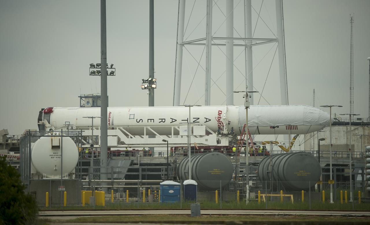 The Orbital Sciences Corporation Antares rocket, with the Cygnus spacecraft onboard, is seen on launch Pad-0A, Thursday, July 10, 2014, at NASA's Wallops Flight Facility in Virginia. The Antares will launch with the Cygnus spacecraft filled with over 3,000 pounds of supplies for the International Space Station, including science experiments, experiment hardware, spare parts, and crew provisions. The Orbital-2 mission is Orbital Sciences' second contracted cargo delivery flight to the space station for NASA. Photo Credit: (NASA/Bill Ingalls)