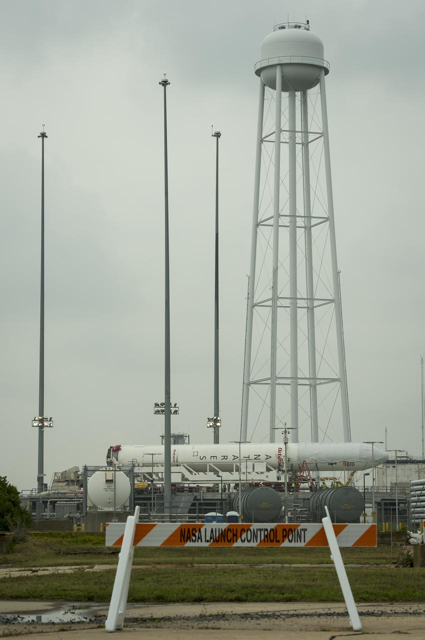 The Orbital Sciences Corporation Antares rocket, with the Cygnus spacecraft onboard, is seen on launch Pad-0A, Thursday, July 10, 2014, at NASA's Wallops Flight Facility in Virginia. The Antares will launch with the Cygnus spacecraft filled with over 3,000 pounds of supplies for the International Space Station, including science experiments, experiment hardware, spare parts, and crew provisions. The Orbital-2 mission is Orbital Sciences' second contracted cargo delivery flight to the space station for NASA. Photo Credit: (NASA/Bill Ingalls)