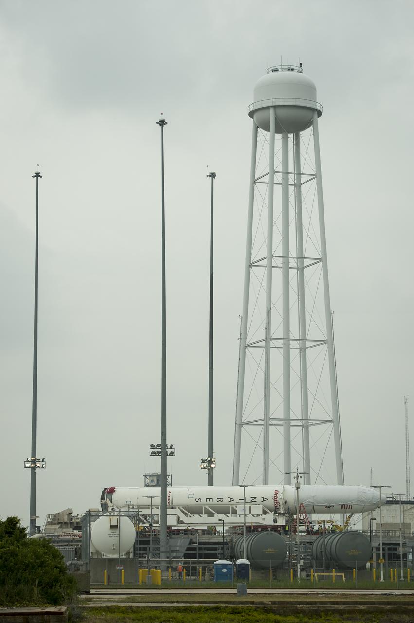 The Orbital Sciences Corporation Antares rocket, with the Cygnus spacecraft onboard, is seen on launch Pad-0A, Thursday, July 10, 2014, at NASA's Wallops Flight Facility in Virginia. The Antares will launch with the Cygnus spacecraft filled with over 3,000 pounds of supplies for the International Space Station, including science experiments, experiment hardware, spare parts, and crew provisions. The Orbital-2 mission is Orbital Sciences' second contracted cargo delivery flight to the space station for NASA. Photo Credit: (NASA/Bill Ingalls)