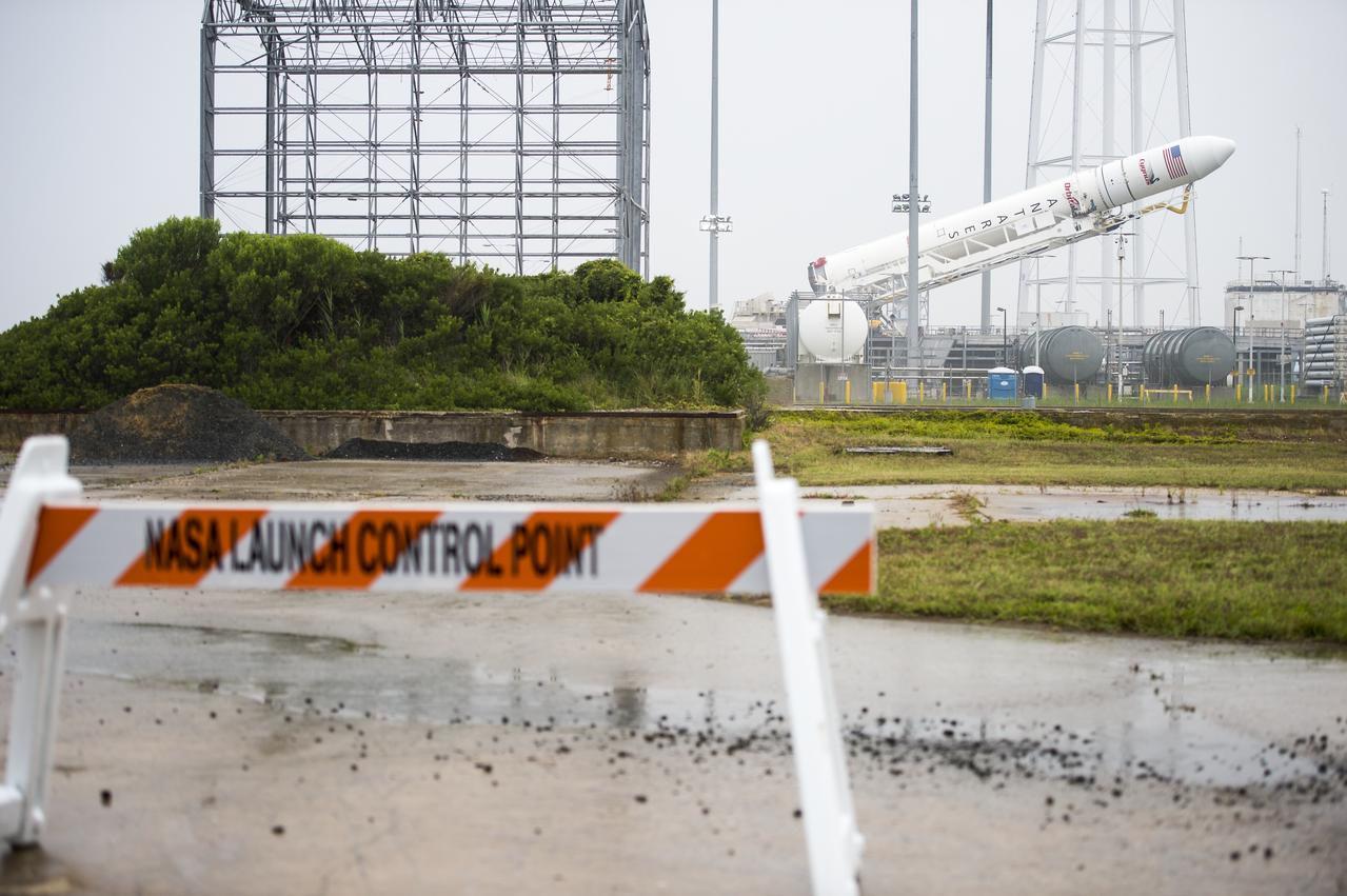 The Orbital Sciences Corporation Antares rocket, with the Cygnus spacecraft onboard, is raised at launch Pad-0A, Thursday, July 10, 2014, at NASA's Wallops Flight Facility in Virginia. The Antares will launch with the Cygnus spacecraft filled with over 3,000 pounds of supplies for the International Space Station, including science experiments, experiment hardware, spare parts, and crew provisions. The Orbital-2 mission is Orbital Sciences' second contracted cargo delivery flight to the space station for NASA. Photo Credit: (NASA/Aubrey Gemignani)