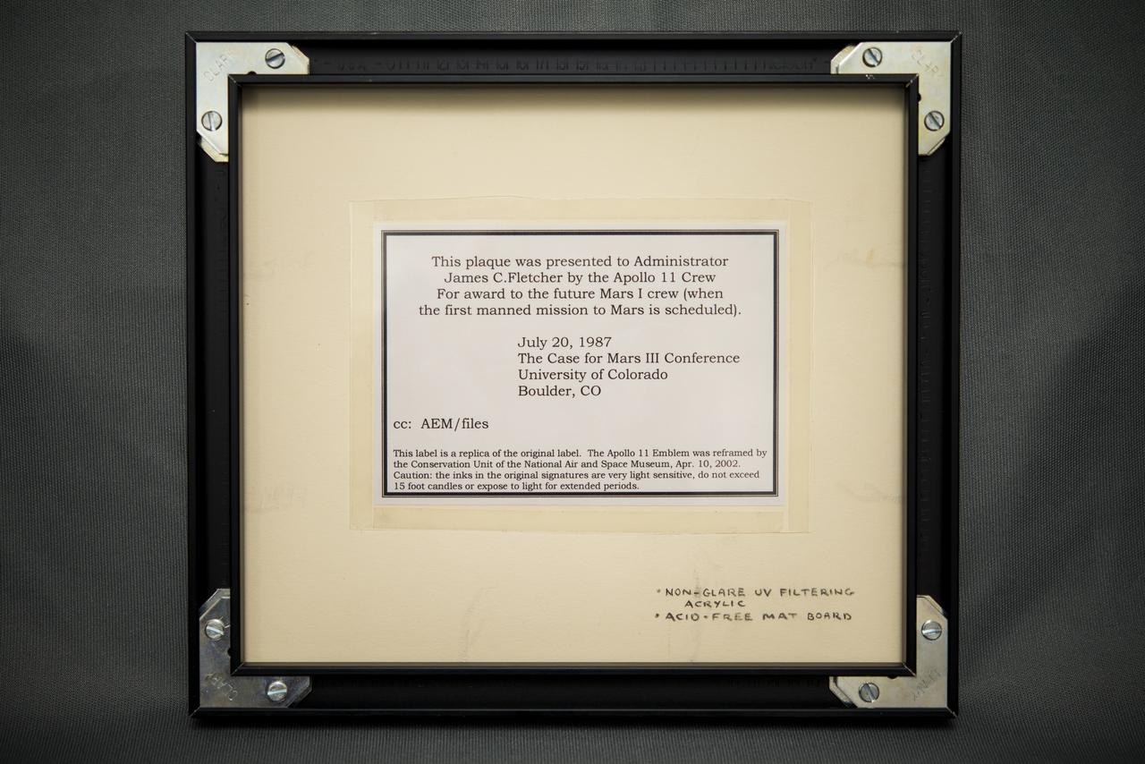 The description on the back of the plaque reads: "This plaque was presented to Administrator James C. Fletcher by the Apollo 11 Crew for award to the future Mars I crew (when the first manned mission to Mars is scheduled),  July 20, 1987 at The Case for Mars III Conference at the University of Colorado in Boulder, Colorado."  Photographed on Friday, July 11, 2014 in Washington, DC.  Photo Credit: (NASA/Joel Kowsky)