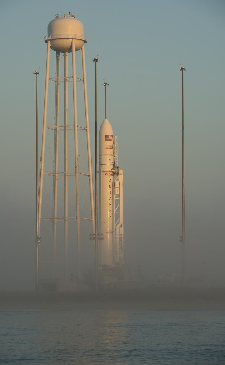 The Orbital Sciences Corporation Antares rocket, with the Cygnus spacecraft onboard, is seen during sunrise, Saturday, July 12, 2014, at launch Pad-0A of NASA's Wallops Flight Facility in Virginia. The Antares will launch with the Cygnus spacecraft filled with over 3,000 pounds of supplies for the International Space Station, including science experiments, experiment hardware, spare parts, and crew provisions. The Orbital-2 mission is Orbital Sciences' second contracted cargo delivery flight to the space station for NASA. Photo Credit: (NASA/Bill Ingalls)