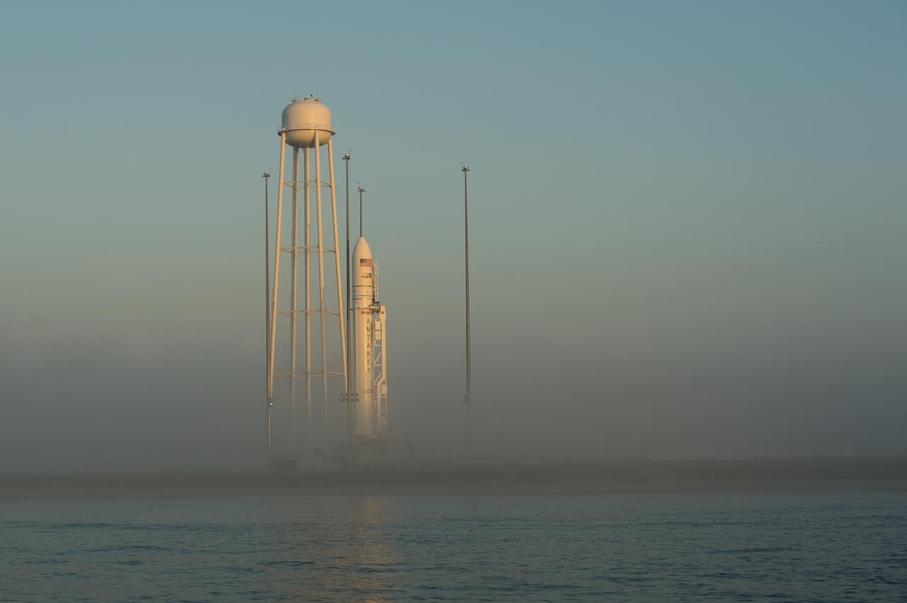 The Orbital Sciences Corporation Antares rocket, with the Cygnus spacecraft onboard, is seen during sunrise, Saturday, July 12, 2014, at launch Pad-0A of NASA's Wallops Flight Facility in Virginia. The Antares will launch with the Cygnus spacecraft filled with over 3,000 pounds of supplies for the International Space Station, including science experiments, experiment hardware, spare parts, and crew provisions. The Orbital-2 mission is Orbital Sciences' second contracted cargo delivery flight to the space station for NASA. Photo Credit: (NASA/Bill Ingalls)