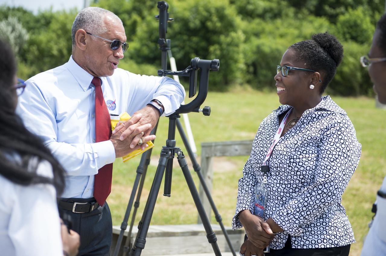 NASA Administrator Charles Bolden (left), speaks with Gina Burgin, Deputy Secretary of Administration, Commonwealth of Virginia, prior to the launch of the Orbital Sciences Corporation Antares rocket, with the Cygnus cargo spacecraft aboard, Sunday, July 13, 2014, at NASA’s Wallops Flight Facility in Virginia. Cygnus will deliver over 3,000 pounds of cargo to the Expedition 40 crew at the International Space Station, including science experiments, experiment hardware, spare parts, and crew provisions. Photo Credit: (NASA/Aubrey Gemignani)