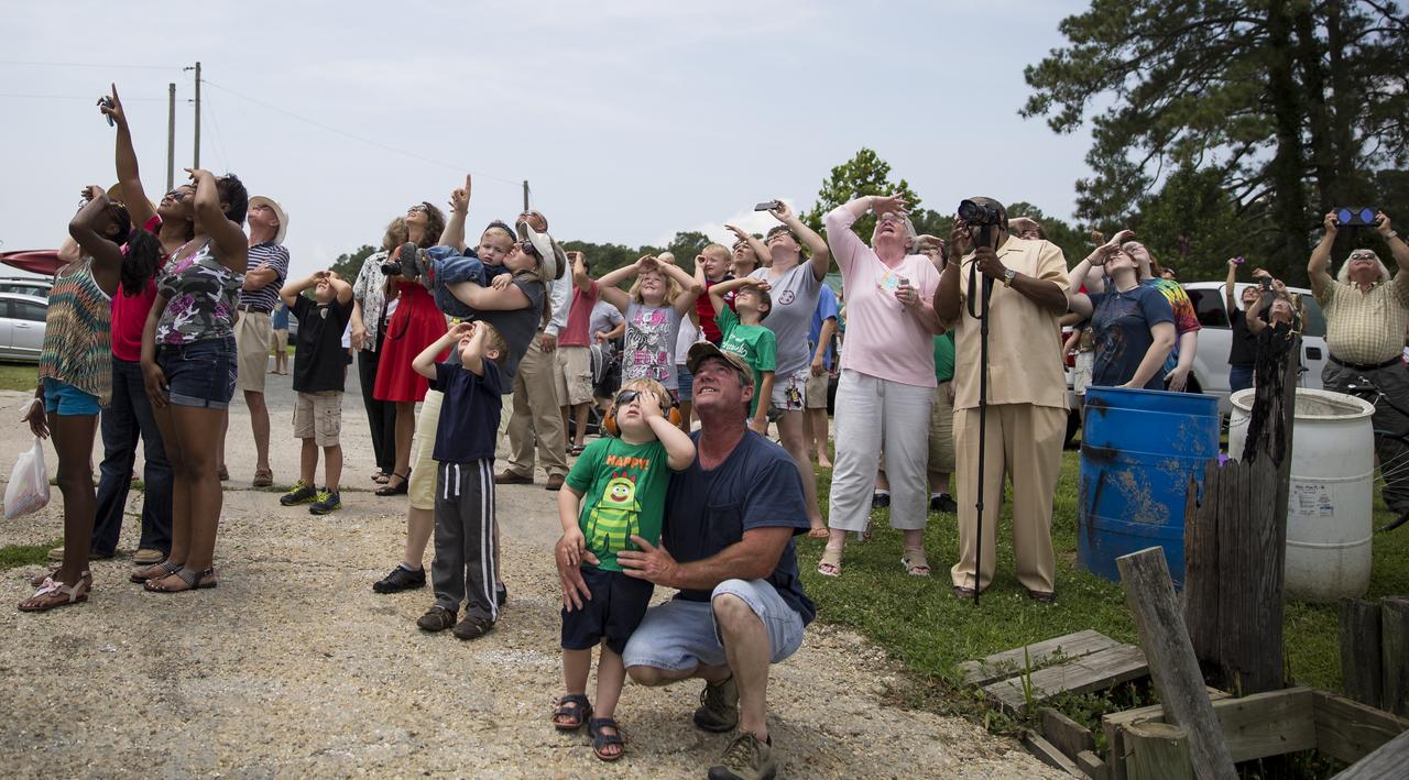 Spectators watch as the Orbital Sciences Corporation Antares rocket launches with the Cygnus spacecraft onboard from NASA's Wallops Flight Facility, Sunday, July 13, 2014, Atlantic, VA. The Cygnus spacecraft is filled with over 3,000 pounds of supplies for the International Space Station, including science experiments, experiment hardware, spare parts, and crew provisions. The Orbital-2 mission is Orbital Sciences' second contracted cargo delivery flight to the space station for NASA. Photo Credit: (NASA/Joel Kowsky)