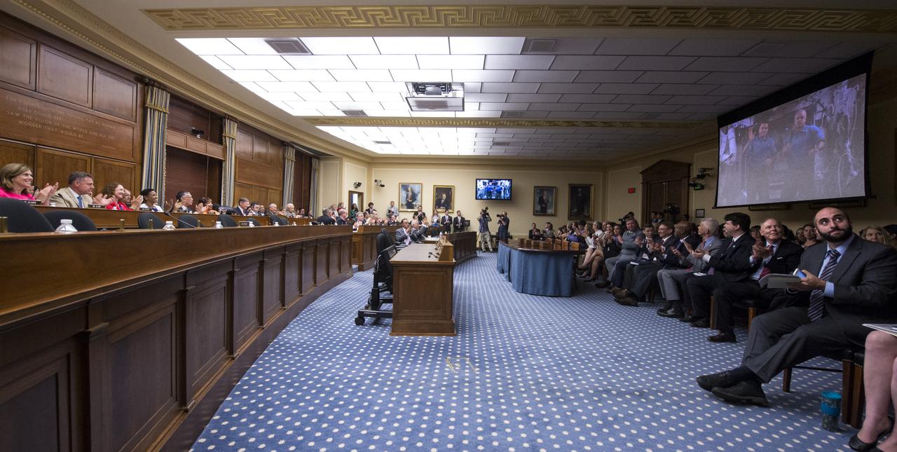 Congress and audience members applaud after a full-committee event held Thursday, July 24, 2014 at the Rayburn House Office Building in Washington, DC to allow members of the Committee on Science, Space, and Technology an opportunity to ask astronauts Steve Swanson and Reid Wiseman questions through a live downlink with the International Space Station (ISS). Expedition 40 astronauts Steve Swanson and Reid Wiseman have been living and working at the ISS for over two months and are scheduled to return to Earth toward the end of this year.