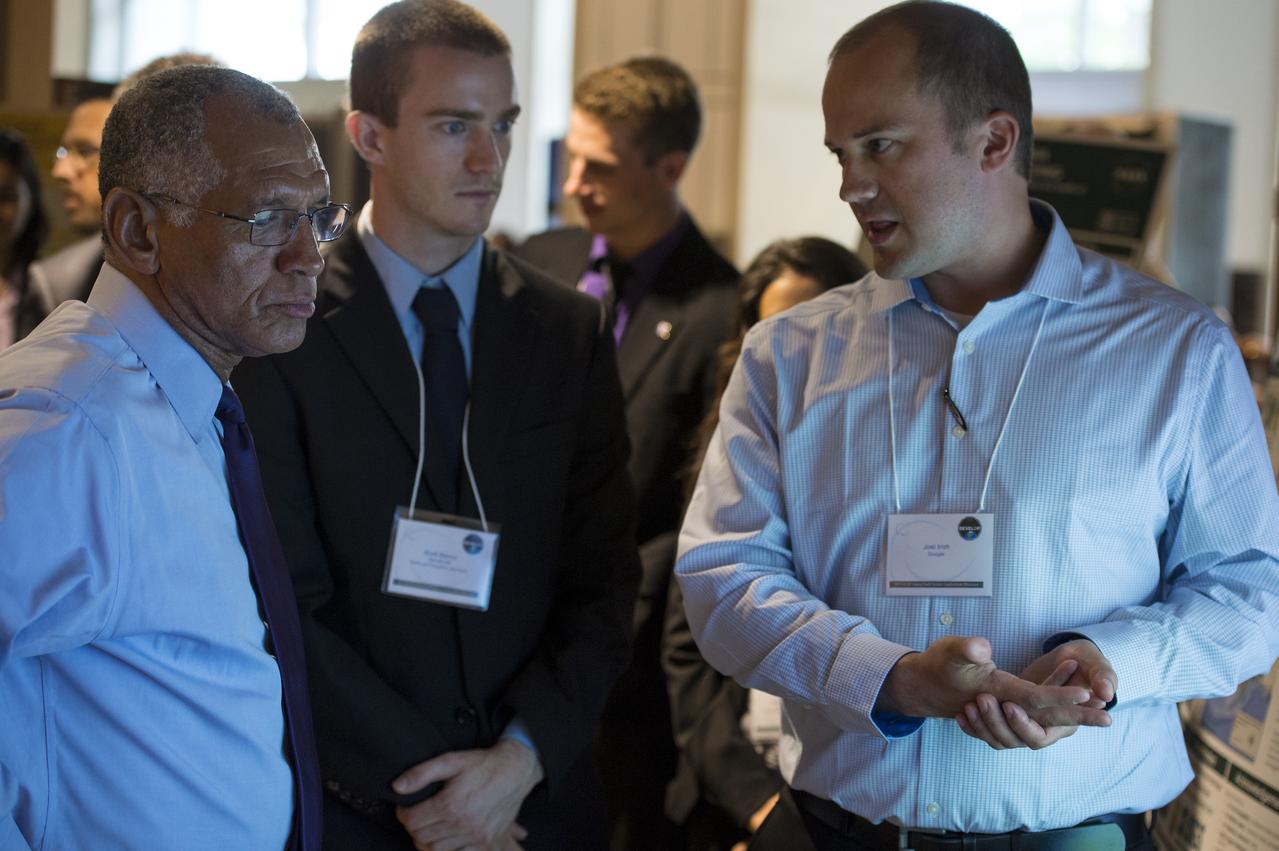 NASA Administrator Charles Bolden speaks with young professionals about their project during the annual DEVELOP Earth Science Application Showcase at NASA headquarters Tuesday, August 5, 2014. The Earth Science Applications Showcase highlights the work of over 150 participants in the 10-week DEVELOP program that started in June. The DEVELOP Program bridges the gap between NASA Earth science and society, building capacity in both its participants and partner organizations, to better prepare them to handle the challenges that face our society and future generations. Photo Credit: (NASA/Aubrey Gemignani)