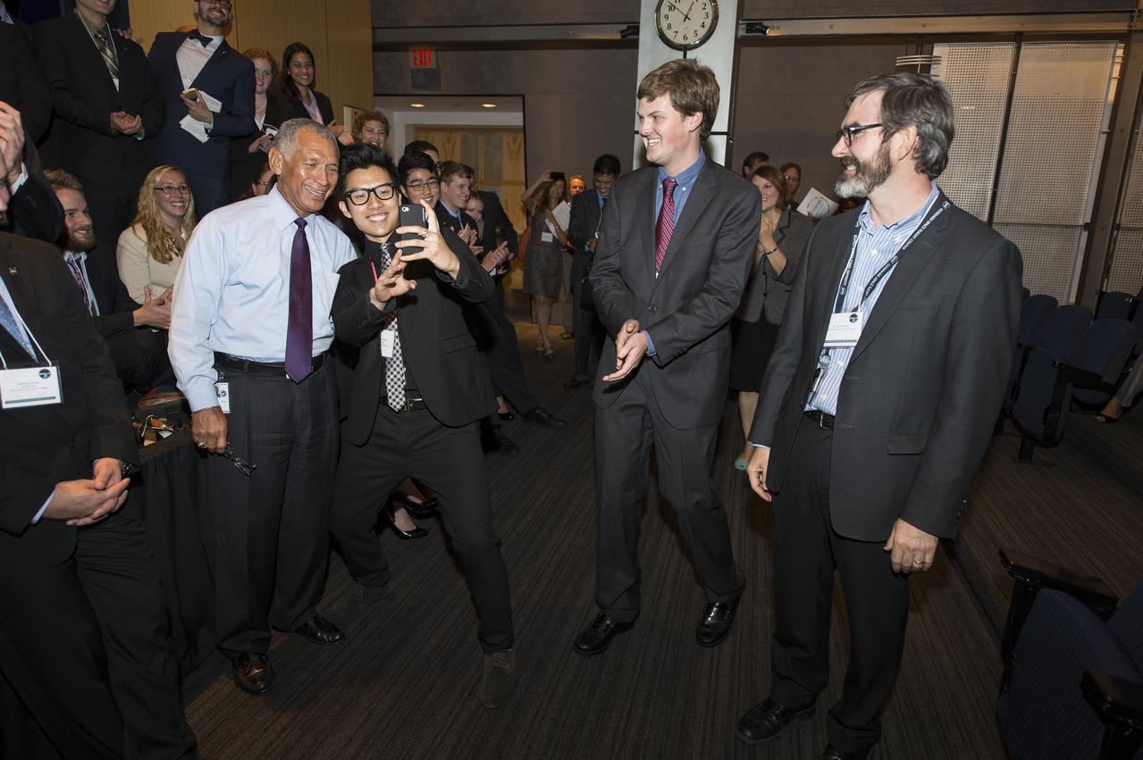 NASA Administrator Charles Bolden poses for a selfie after a quick rap performance by some young professionals during the annual DEVELOP Earth Science Application Showcase at NASA headquarters Tuesday, August 5, 2014. The Earth Science Applications Showcase highlights the work of over 150 participants in the 10-week DEVELOP program that started in June. The DEVELOP Program bridges the gap between NASA Earth science and society, building capacity in both its participants and partner organizations, to better prepare them to handle the challenges that face our society and future generations. Photo Credit: (NASA/Aubrey Gemignani)