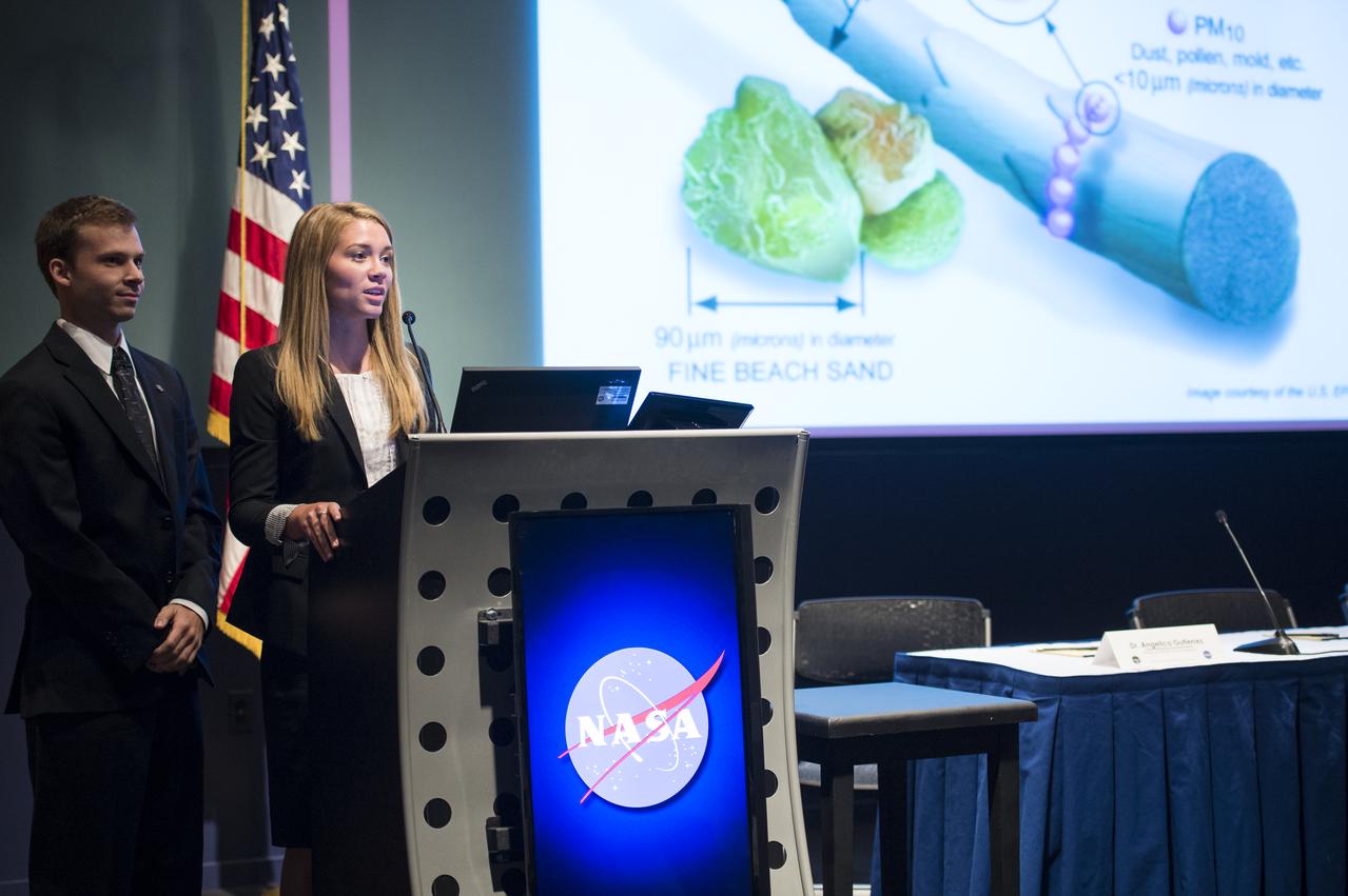 Lisa Waldron and Justin Roberts-Pierel present their project on Texas health and air quality during the annual DEVELOP Earth Science Application Showcase at NASA headquarters Tuesday, August 5, 2014. The Earth Science Applications Showcase highlights the work of over 150 participants in the 10-week DEVELOP program that started in June. The DEVELOP Program bridges the gap between NASA Earth science and society, building capacity in both its participants and partner organizations, to better prepare them to handle the challenges that face our society and future generations. Photo Credit: (NASA/Aubrey Gemignani)