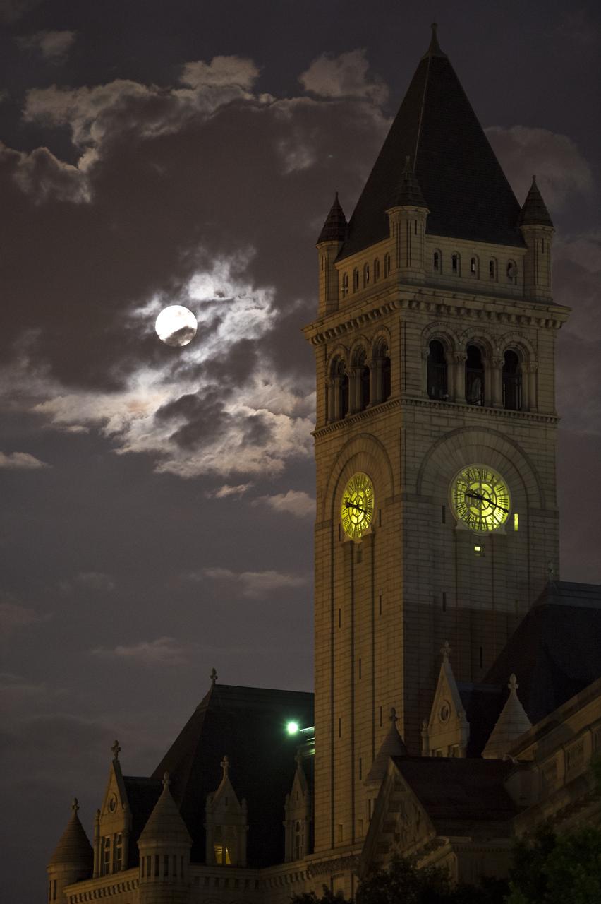 A perigee full moon or supermoon is seen over the Old Post Office and Clock Tower, Sunday, August 10, 2014, in Washington. A supermoon occurs when the moon’s orbit is closest (perigee) to Earth at the same time it is full. Photo Credit: (NASA/Bill Ingalls)