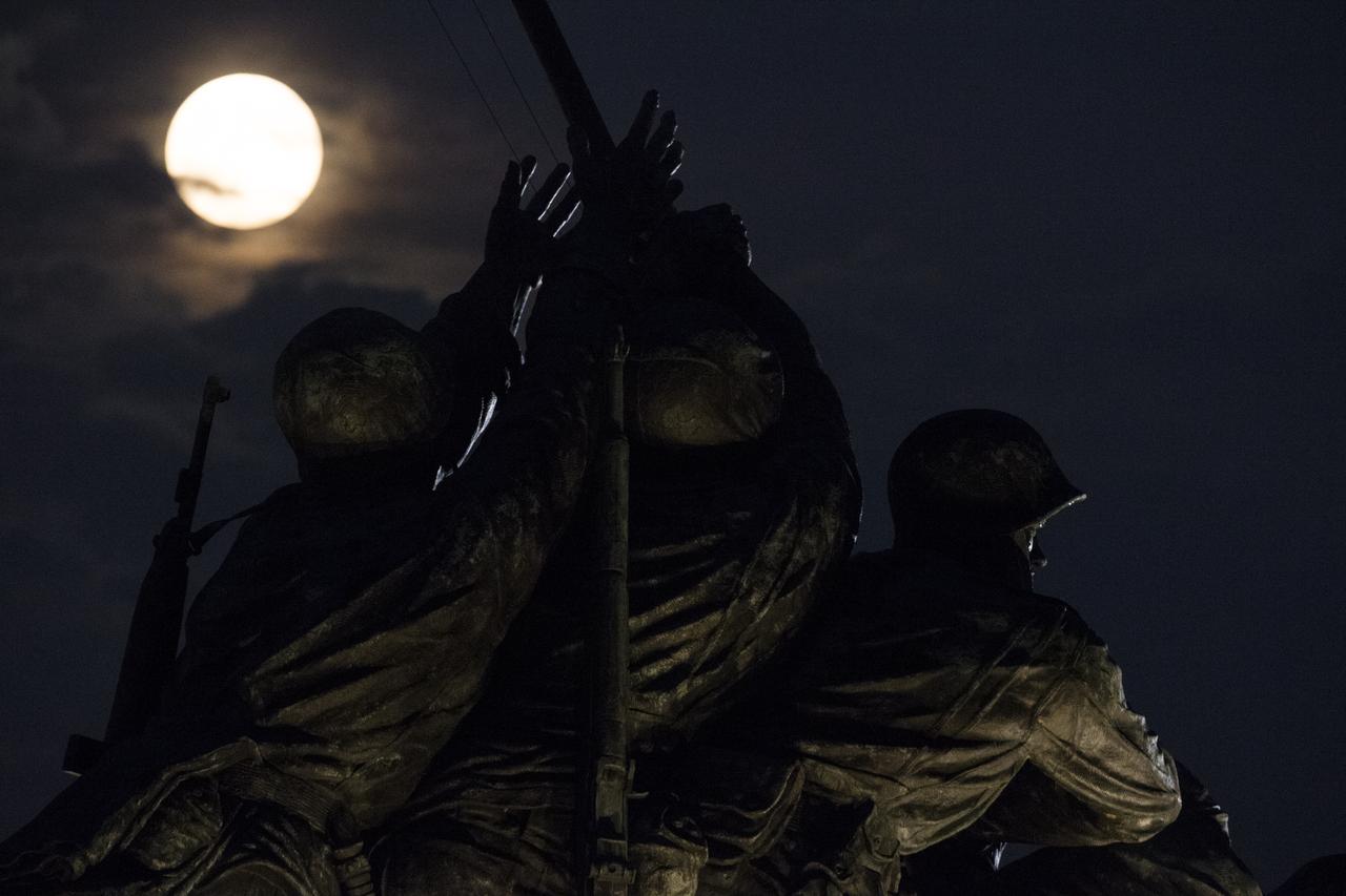 A perigree full moon or supermoon is seen over the US Marine Corps War Memorial, Sunday, August 10, 2014, in Arlington, Virginia. A supermoon occurs when the moon’s orbit is closest (perigee) to Earth at the same time it is full.  Photo Credit: (NASA/Joel Kowsky)