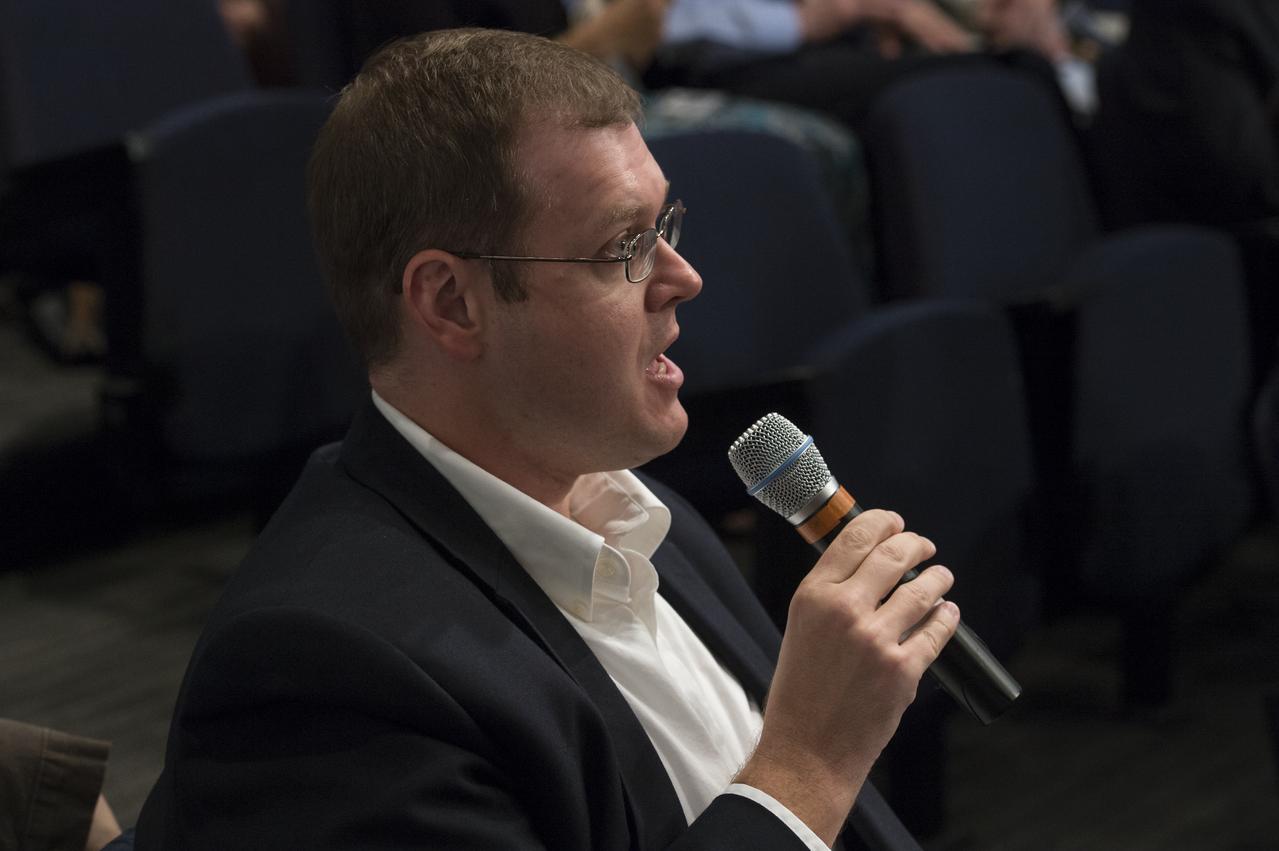 An audience member asks the panelists a question at the "New Horizons: The First Mission to the Pluto System and the Kuiper Belt" Event at NASA Headquarters in Washington, DC Monday, August 25, 2014. Scientists discussed how the first images of Pluto and its moons would be captured by the New Horizons spacecraft during a five month long reconnaissance flyby study starting in the summer of 2015.  New Horizons launched on January 19, 2006 and is scheduled to make its closest approach to Pluto on July 14, 2015. Photo Credit: (NASA/Aubrey Gemignani)