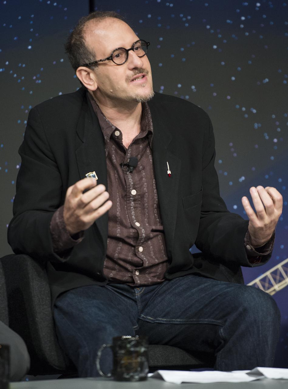 Dr. David H. Grinspoon, senior scientist at the Planetary Science Institute, speaks about working on NASA's Voyager team while serving as moderator for a panel discussion at the "NASA's New Horizons Pluto Mission: Continuing Voyager's Legacy of Exploration" event on Monday, August, 25, 2014, in the James E. Webb Auditorium at NASA Headquarters in Washington, DC.  The panelists gave their accounts of Voyager's encounter with Neptune and discussed their current assignments on NASA's New Horizons mission to Pluto.  Photo Credit: (NASA/Joel Kowsky)